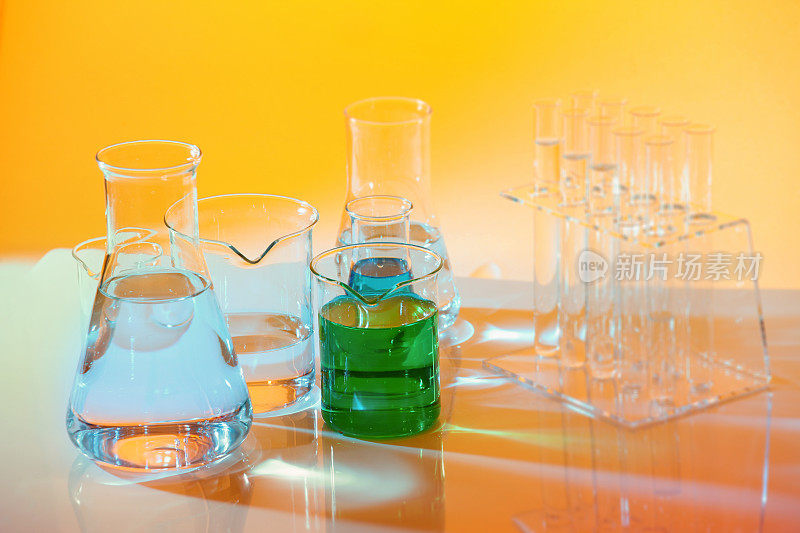 化学实验室黄色底色，烧杯，绿色液体，试管，烧瓶