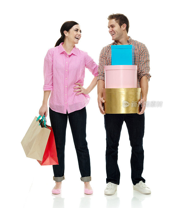 白人女性购物狂站在白色背景穿着纽扣衬衫和拿着礼盒
