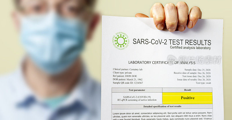 一份戴防护口罩的男子携带的SARS-CoV-2冠状病毒感染的COVID-19阳性检测结果文件