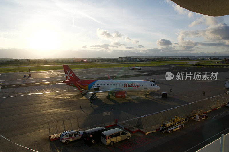 日落时分，马耳他国家航空公司的一架飞机停在国际机场门口