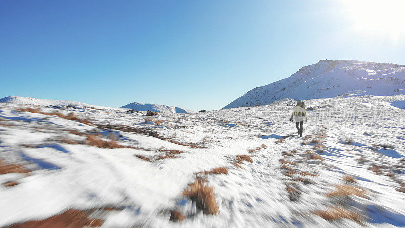 背包客在雪山上徒步旅行的鸟瞰图