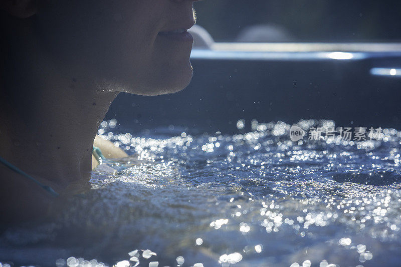 女人在漩涡热水浴缸里。水疗和健康水疗。