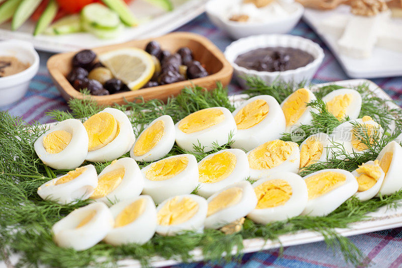 早餐桌上的盘子里有煮熟的鸡蛋。