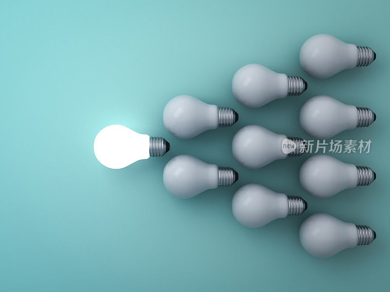 一个发光的灯泡从绿色背景的白炽灯中脱颖而出，领导和不同的概念