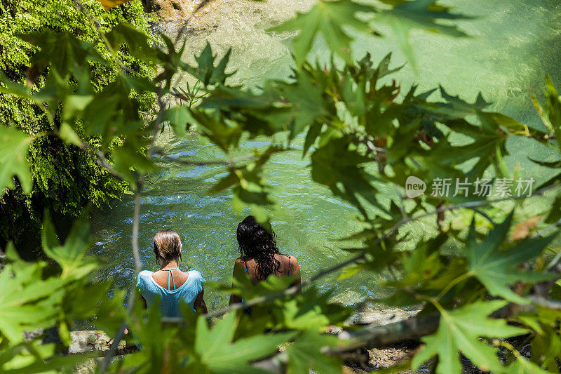 瀑布边的女人。奥卢德尼兹卡巴克湾的阿拉德尔瀑布。Fethiye,土耳其。