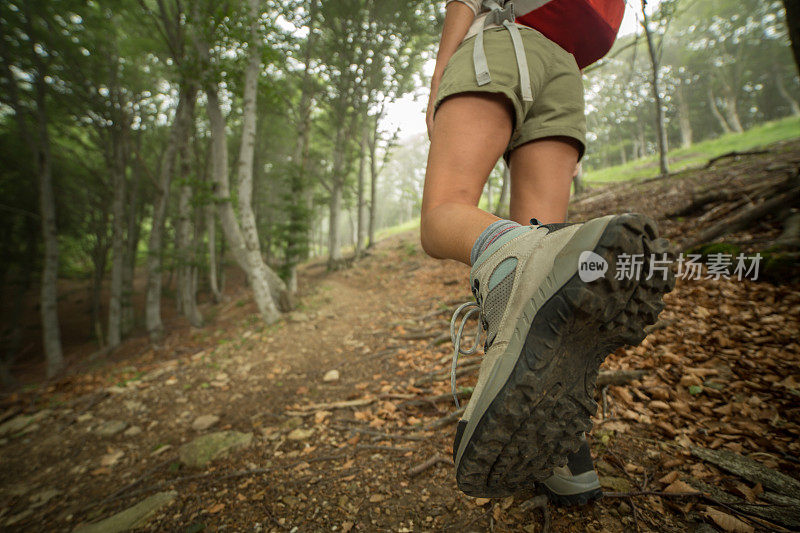 一个徒步旅行者的腿在山路上的特写镜头