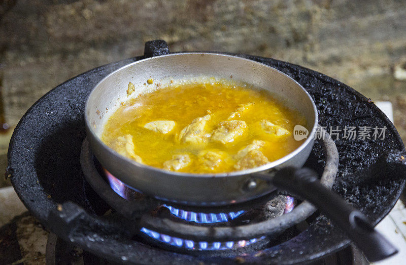 鸡肉咖喱在煤气炉上烹饪。