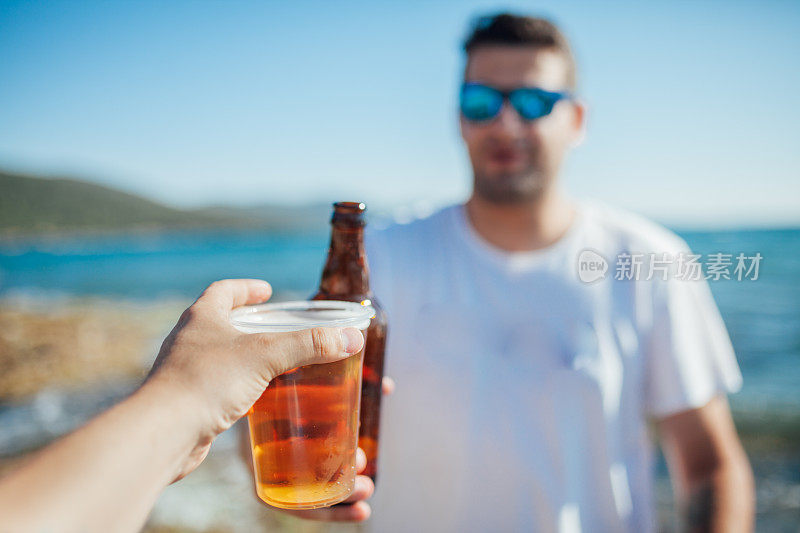 朋友们在海滩上喝啤酒
