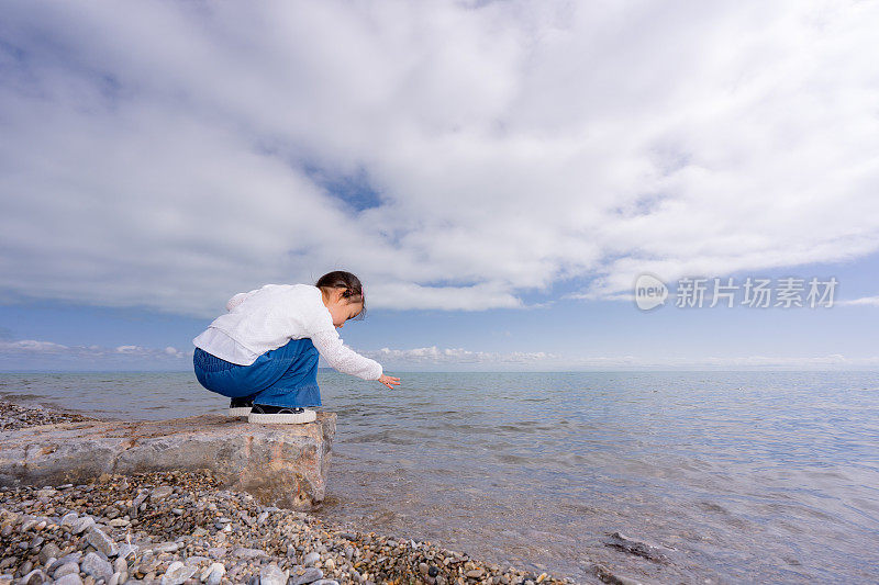 一个小女孩在湖边玩耍