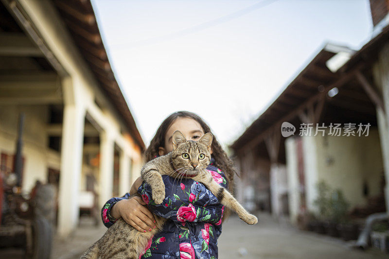 一个小孩抱着她的宠物猫