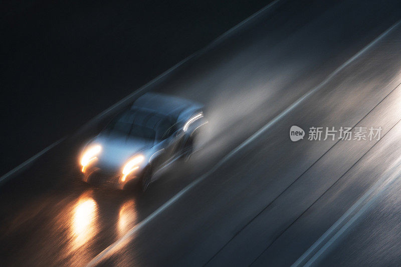 开着前灯的汽车在大雨中行驶