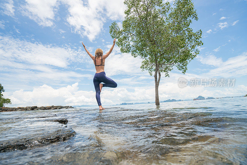 瑜伽妇女在热带气候中锻炼