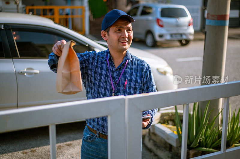 一个亚洲送货员在送食物