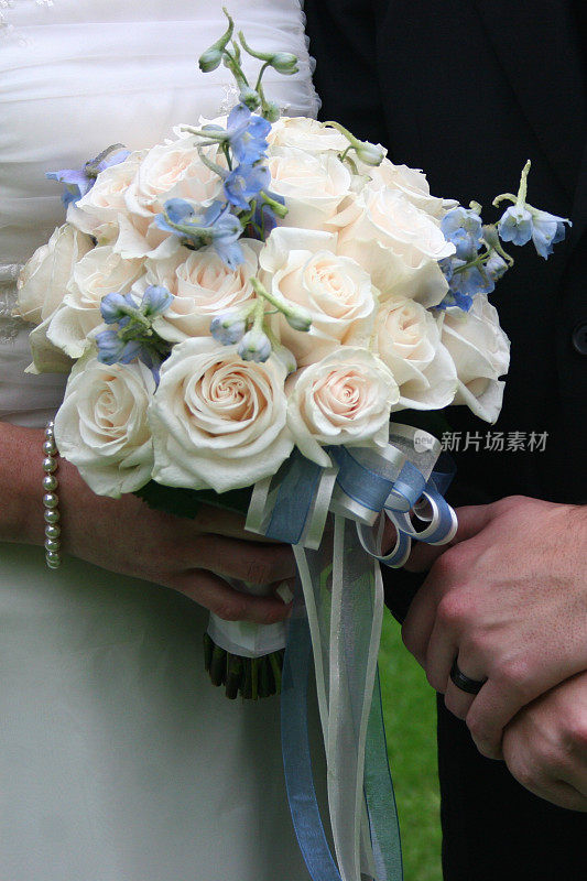 新娘和新郎捧着婚礼花束