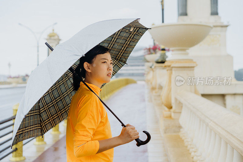 撑着伞在雨中走