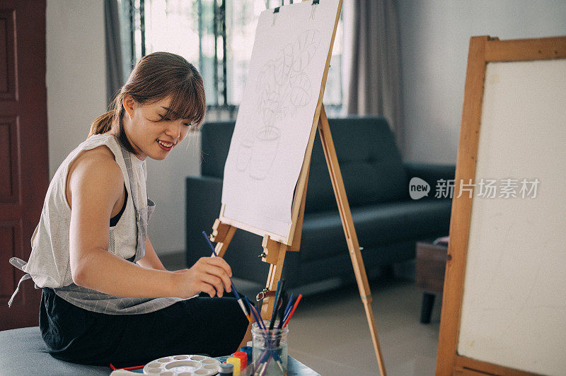 那个快乐的女人正在画架上画画
