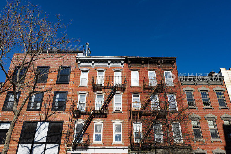 位于纽约布鲁克林威廉斯堡的一排带消防通道的彩色老砖住宅