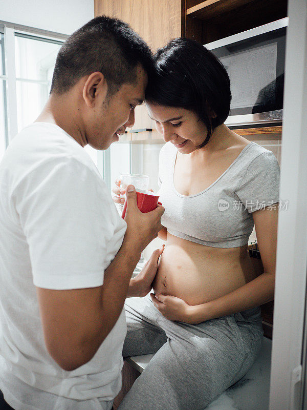 丈夫和怀孕的妻子一起在厨房里，