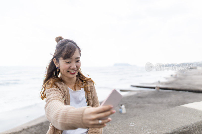 年轻女子在海滩自拍