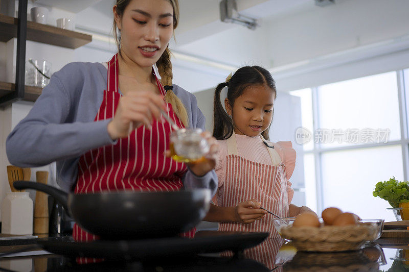 母女俩在厨房做饭。