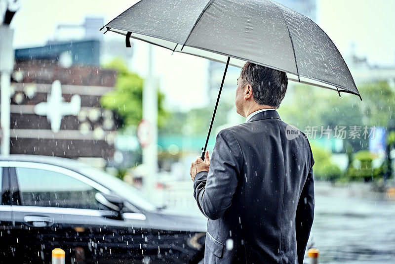 男性专业人士在雨天出差