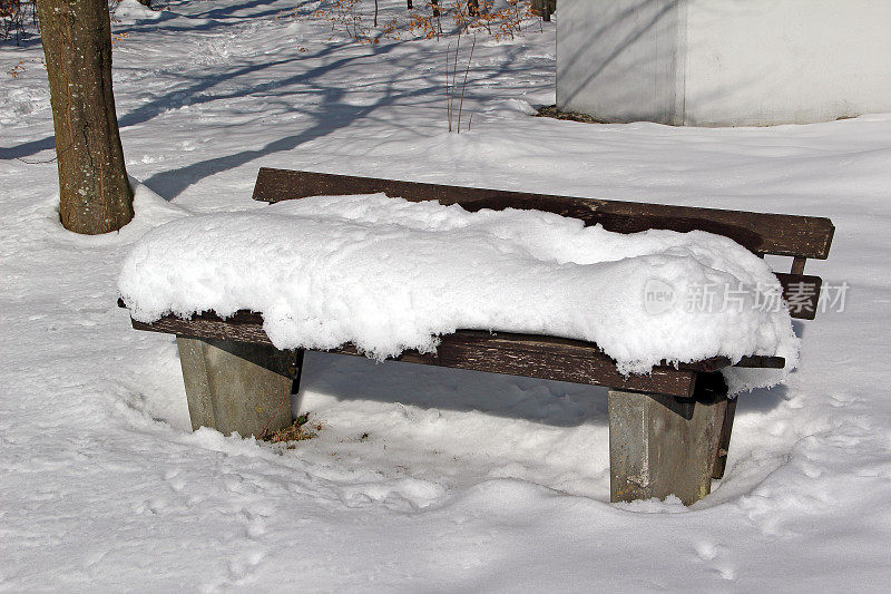 长凳上积着厚厚的一层雪