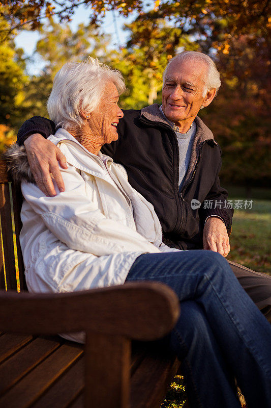 一对老年情侣在长椅上拥抱