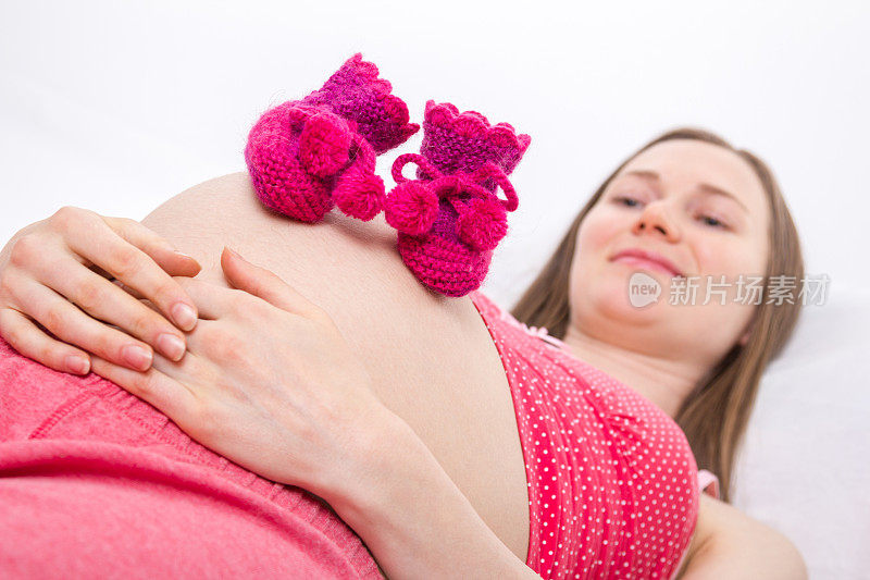 孕妇腹部的婴儿鞋