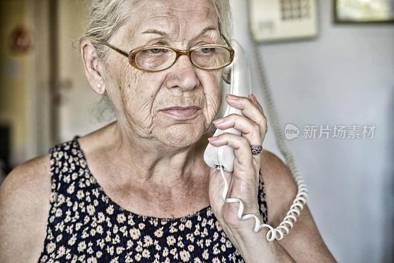 沮丧的年长妇女收到坏消息在她的家里