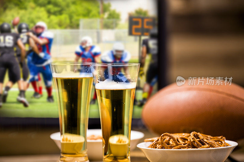 在电视上看足球比赛。零食、啤酒、球。酒吧,回家。