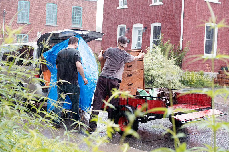 两个学生在一个下雨天搬家具