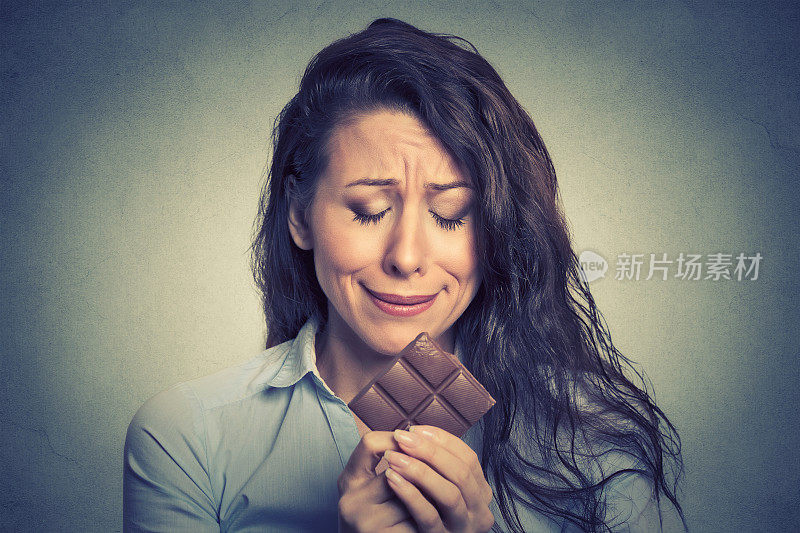 可悲的年轻女人厌倦了饮食限制，渴望甜食和巧克力