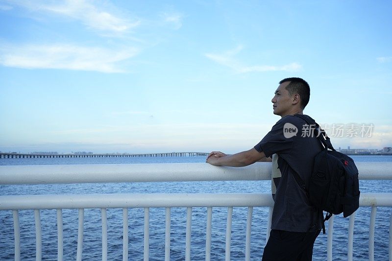 一位男乘客在观景台上看海