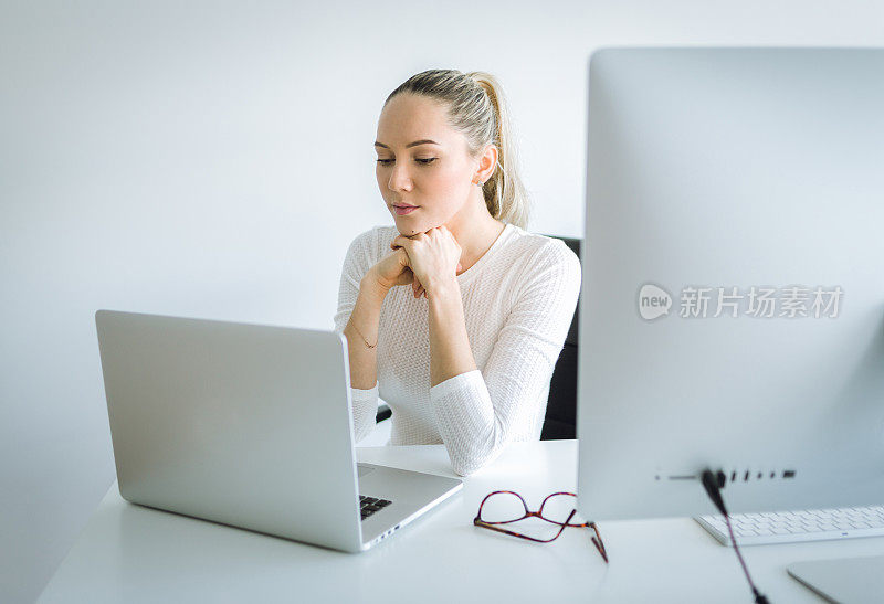 在办公室使用笔记本电脑的女人
