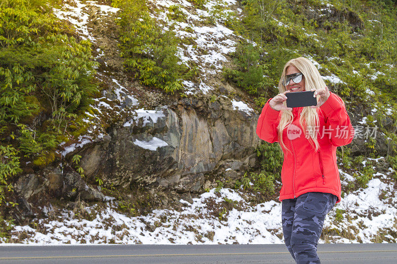 肖像成熟的幸福活跃的中年妇女徒步在雪地的冬天森林