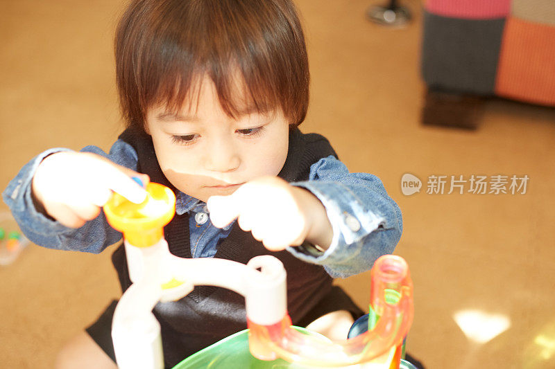 小男孩专注于他的玩具