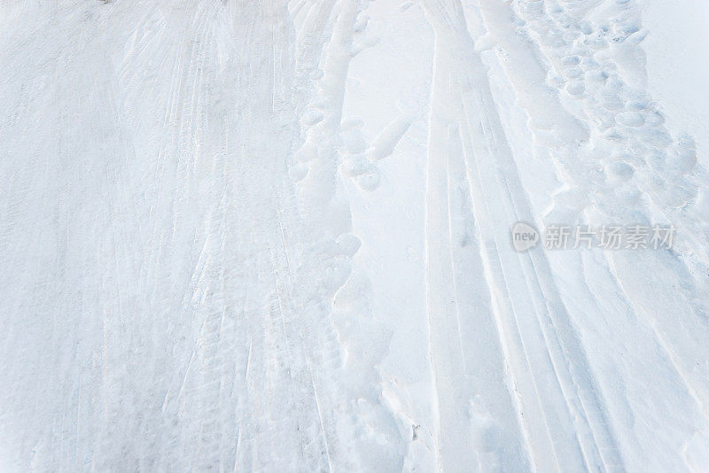 雪地上的车胎痕迹和脚印