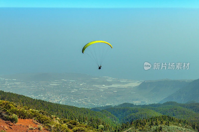 西班牙特内里费岛马尔佩斯海滩的埃尔泰达火山下的滑翔伞