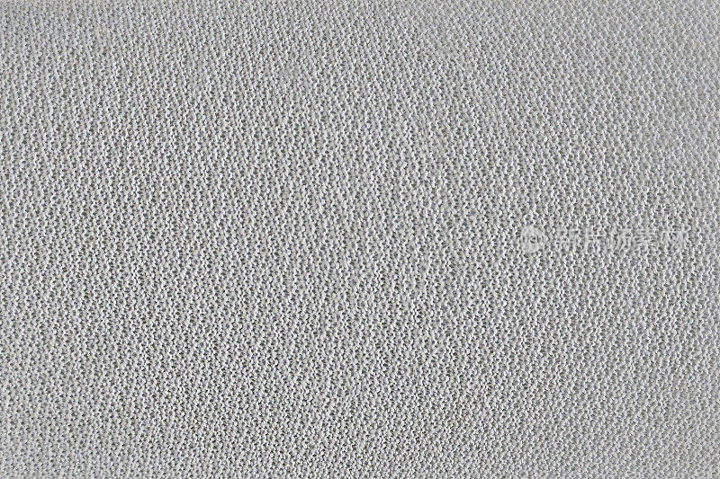 白色织物的纹理与卷曲。卷曲成均匀织物的毛线整齐的布上的白色卷曲的线。