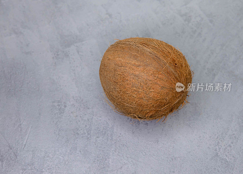 不完美的椰子。高角度的椰子反对灰色背景。