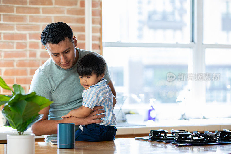 父亲和儿子在现代厨房里看着智能家居设备