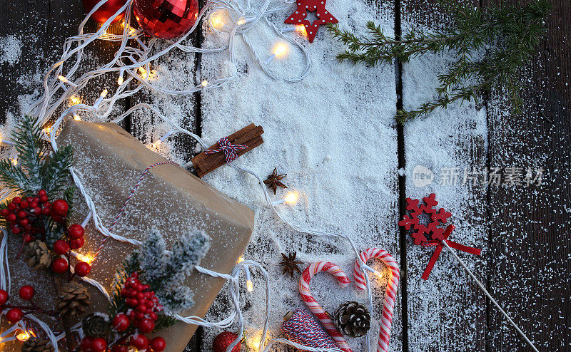 圣诞背景与礼盒，冷杉树枝，线索的绳子，手工木制圣诞装饰，闪闪发光的五彩纸屑星星。圣诞节、冬天、新年概念。顶部视图与复制空间库存照片