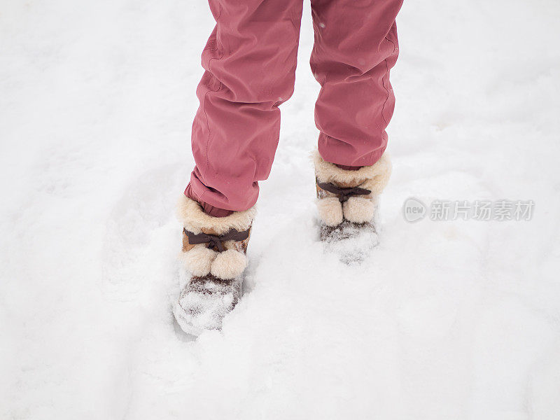 站在雪地上的小女孩