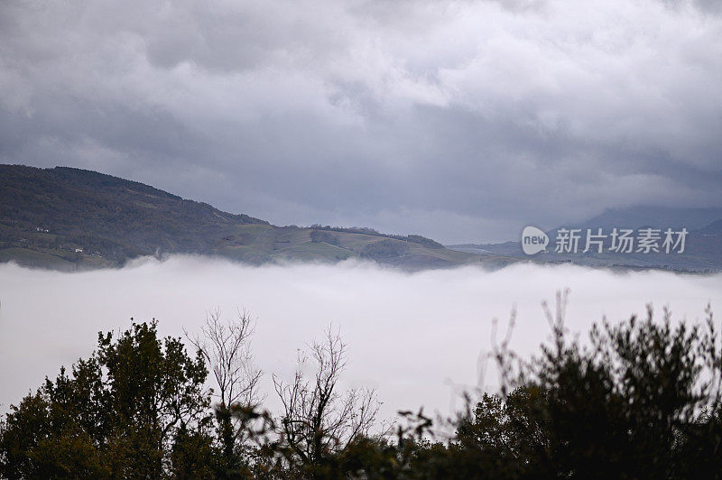 恶劣的天气，山上有雨云和雾。