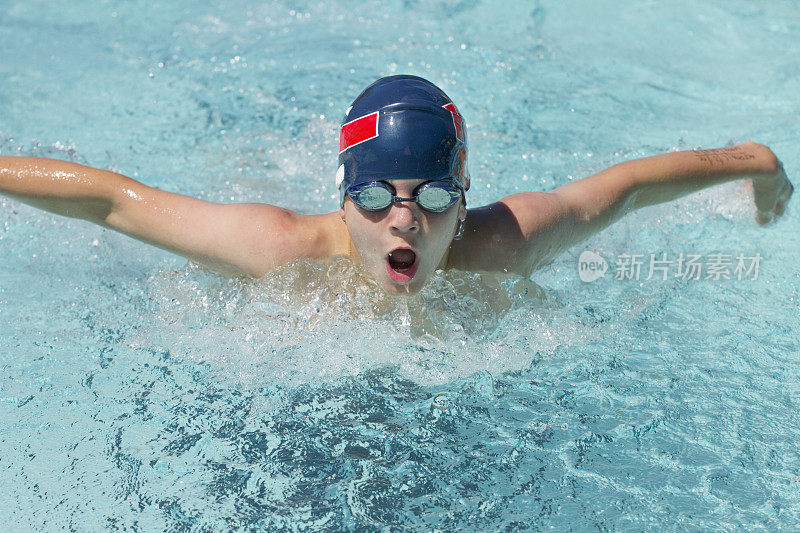 男孩在比赛中游泳蝶泳