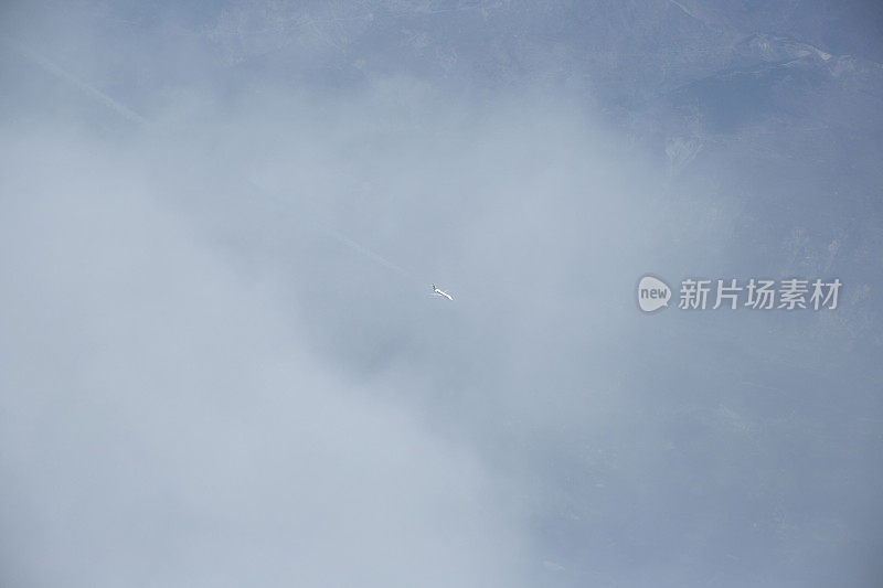 在意大利，一架小飞机飞过云层进入天空