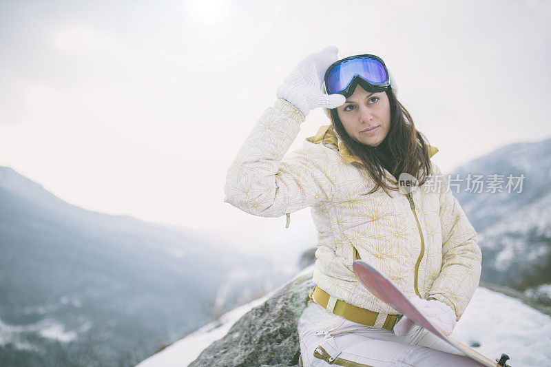 冬天穿着滑雪服的女人靠近滑雪板