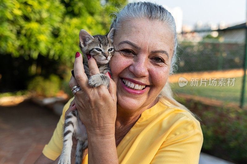 一个快乐的女人抱着刚收养的猫