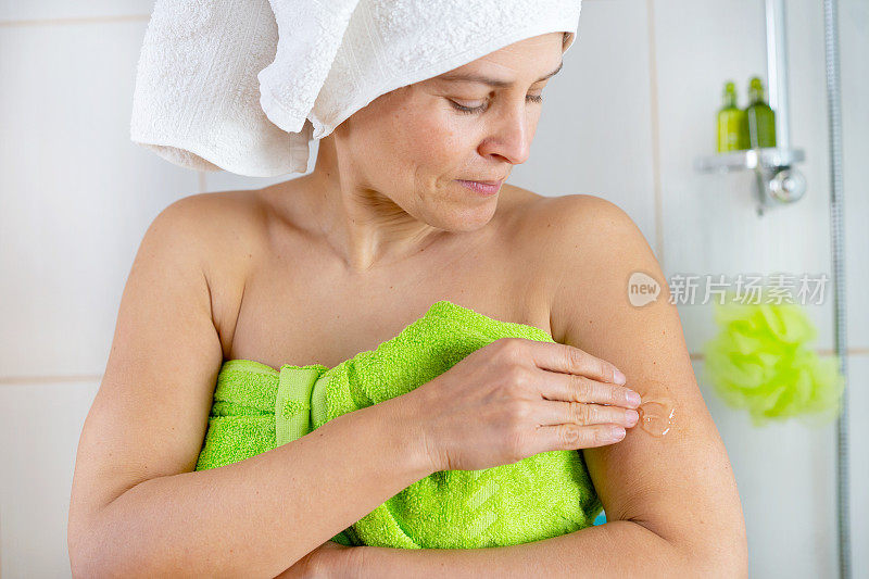 一名妇女在手臂上涂抹药膏以缓解更年期