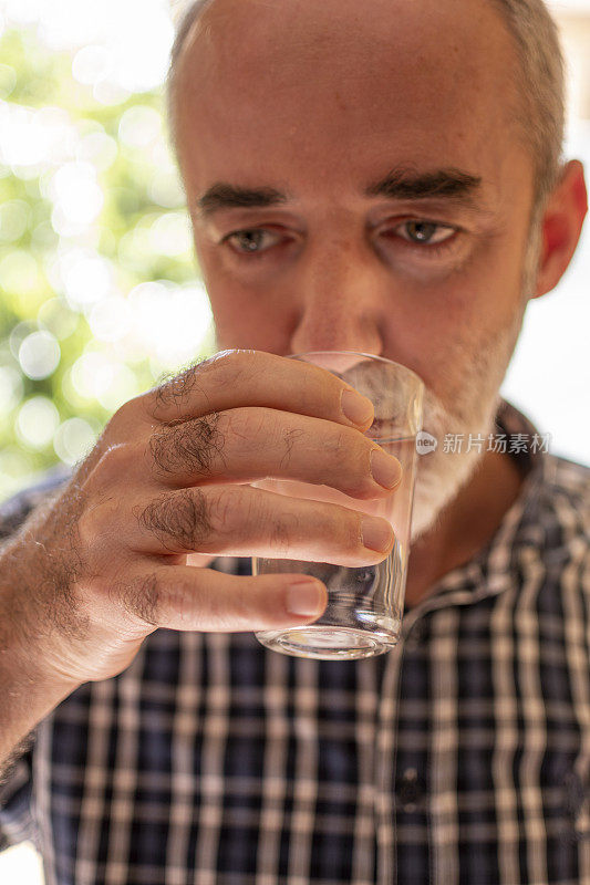 一个拿着一杯水的手的特写